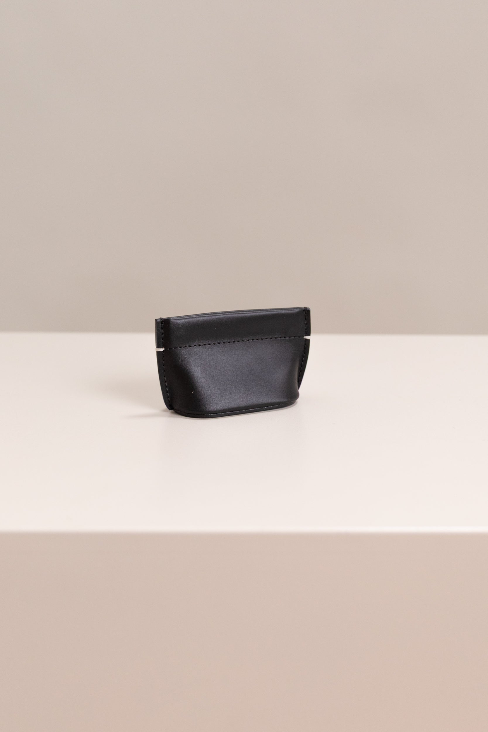 COIN DUMPLING IN BLACK LEATHER