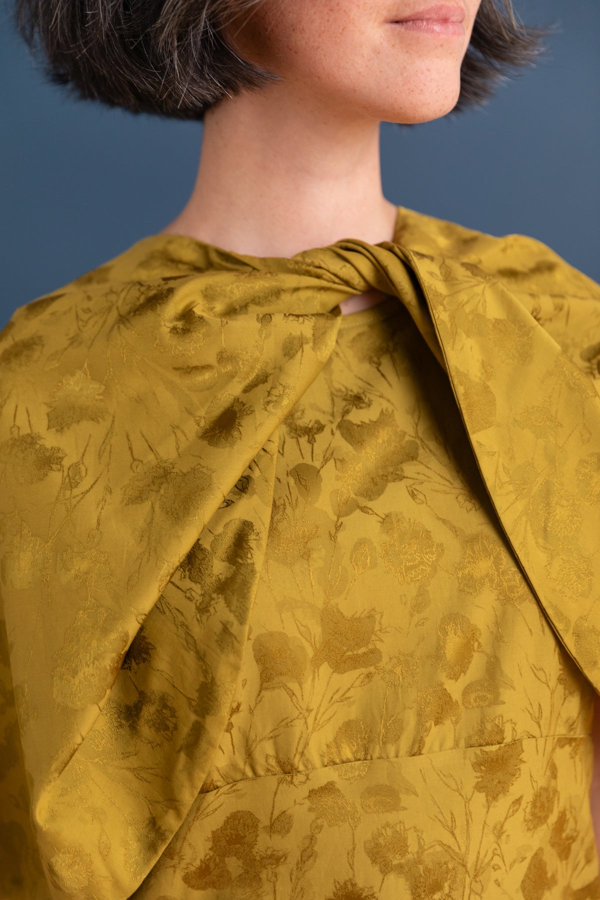 TWISTED CAPE IN GOLDEN OCHRE FLORAL JACQUARD