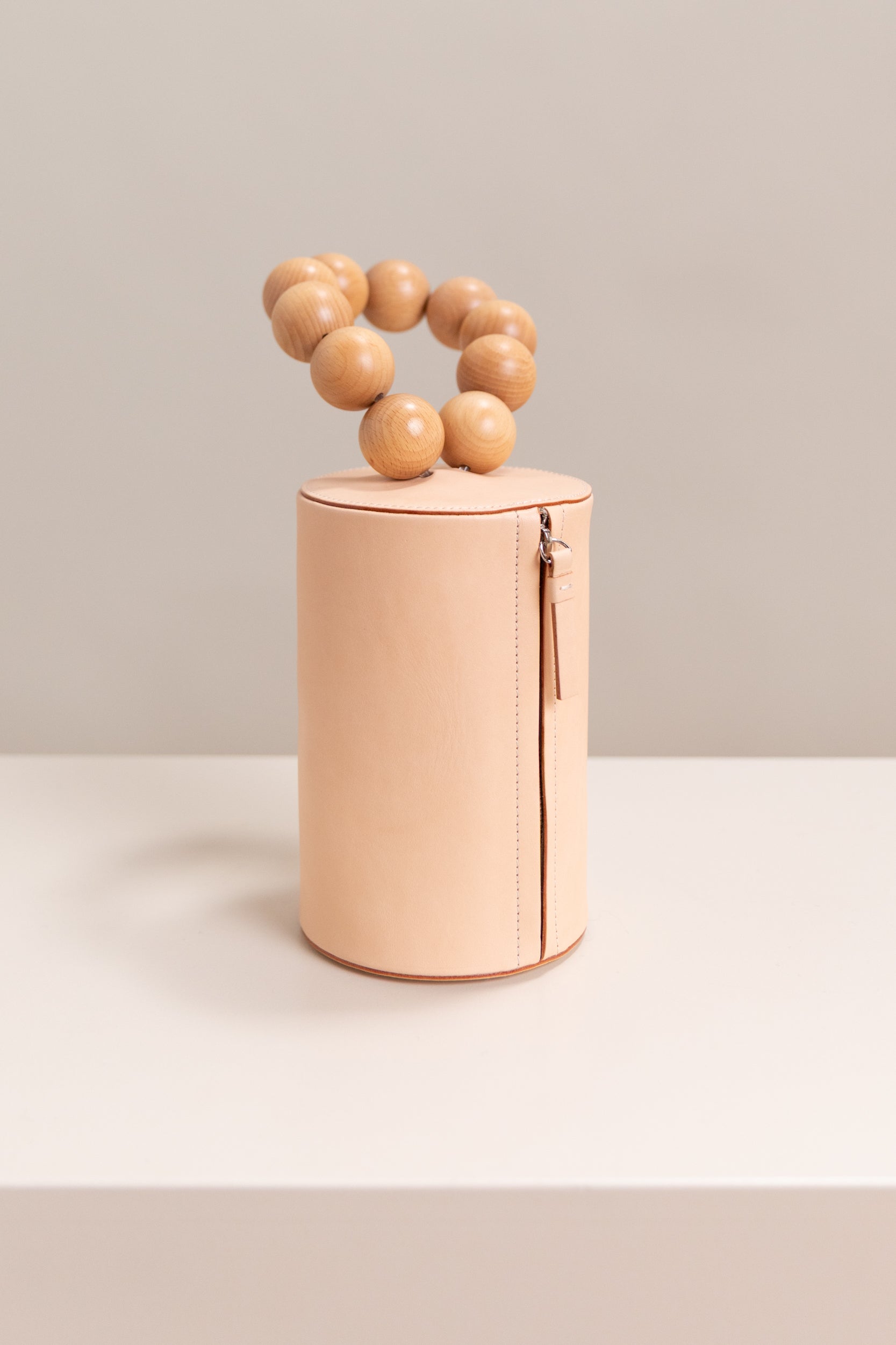 WOOD BALL WRISTLET BAG IN VEG TAN LEATHER