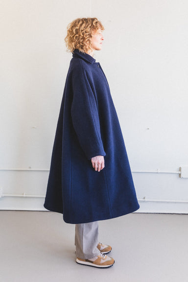 The Roo Coat features an oversized, classic silhouette with an full A-line shape, a pointed collar and button closure. The fabric is a Portuguese boiled wool.