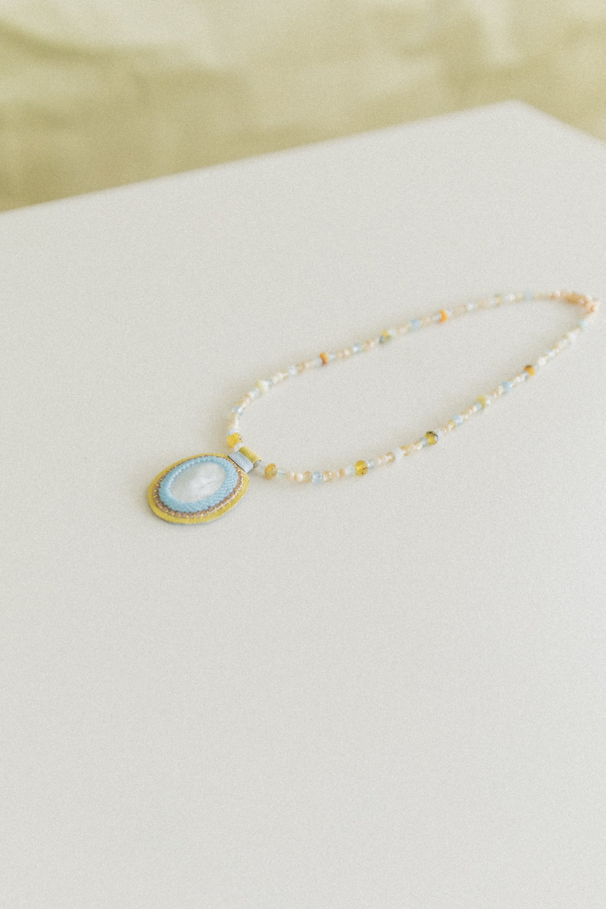 LOVE BEAD CHARM NECKLACE WITH A MOTHER-OF-PEARL CHARM